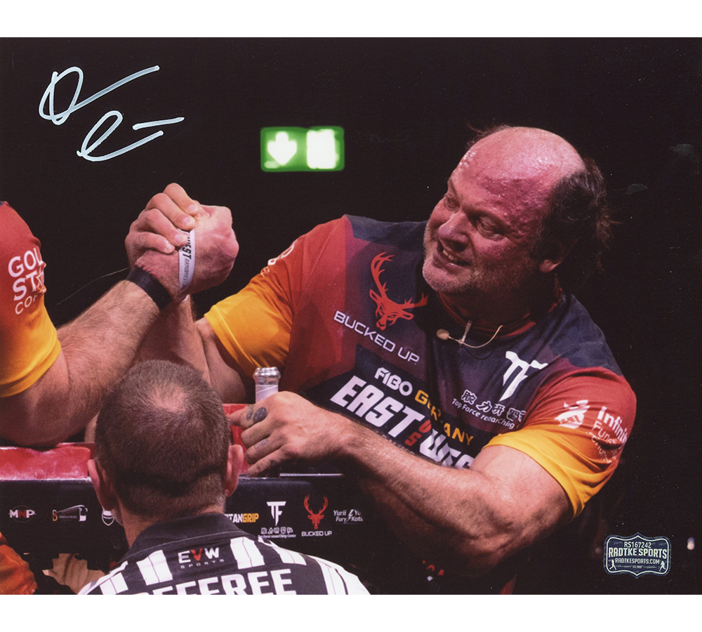 Devon Larratt Signed Unframed 8x10 Arm Wrestling Photo - Black, Red and Yellow Shirt